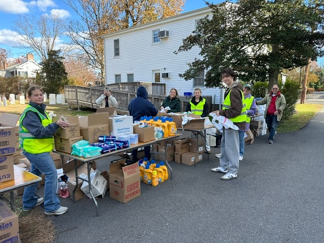 Volunteers sorting donations outdoors at Skeet's Pantry